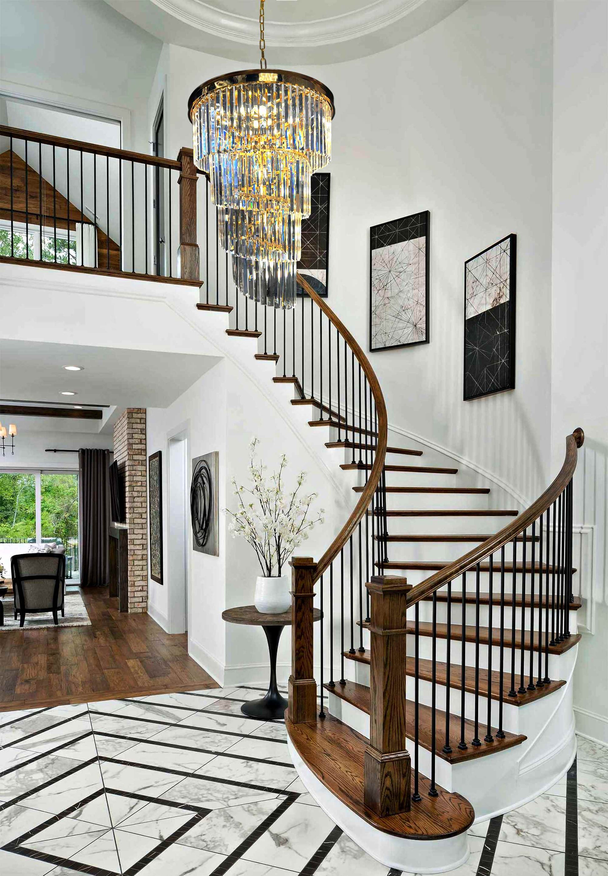 Tiered gold chandelier above staircase foyer