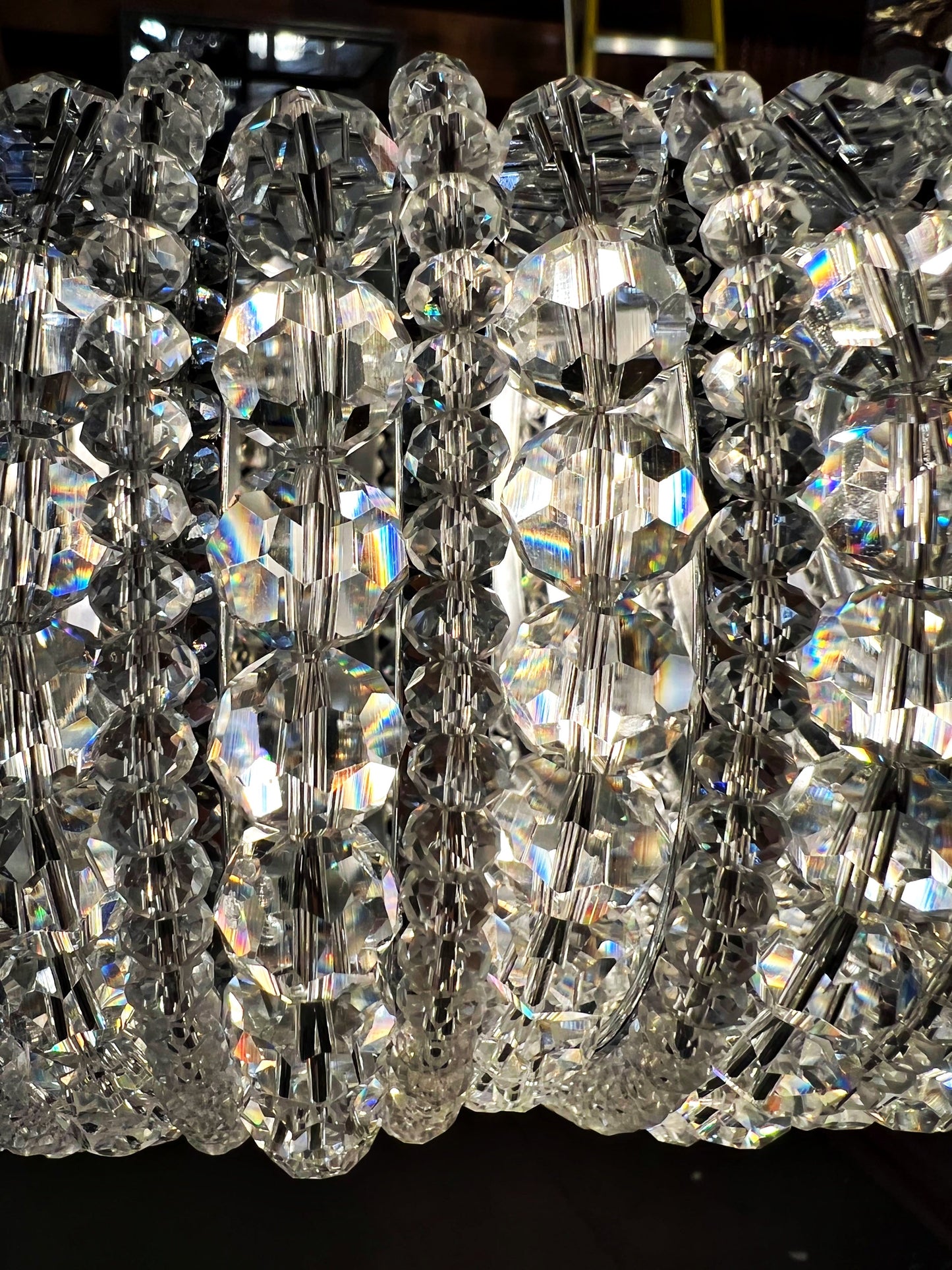 Chrome halo chandelier with layered crystals and polished circular frame