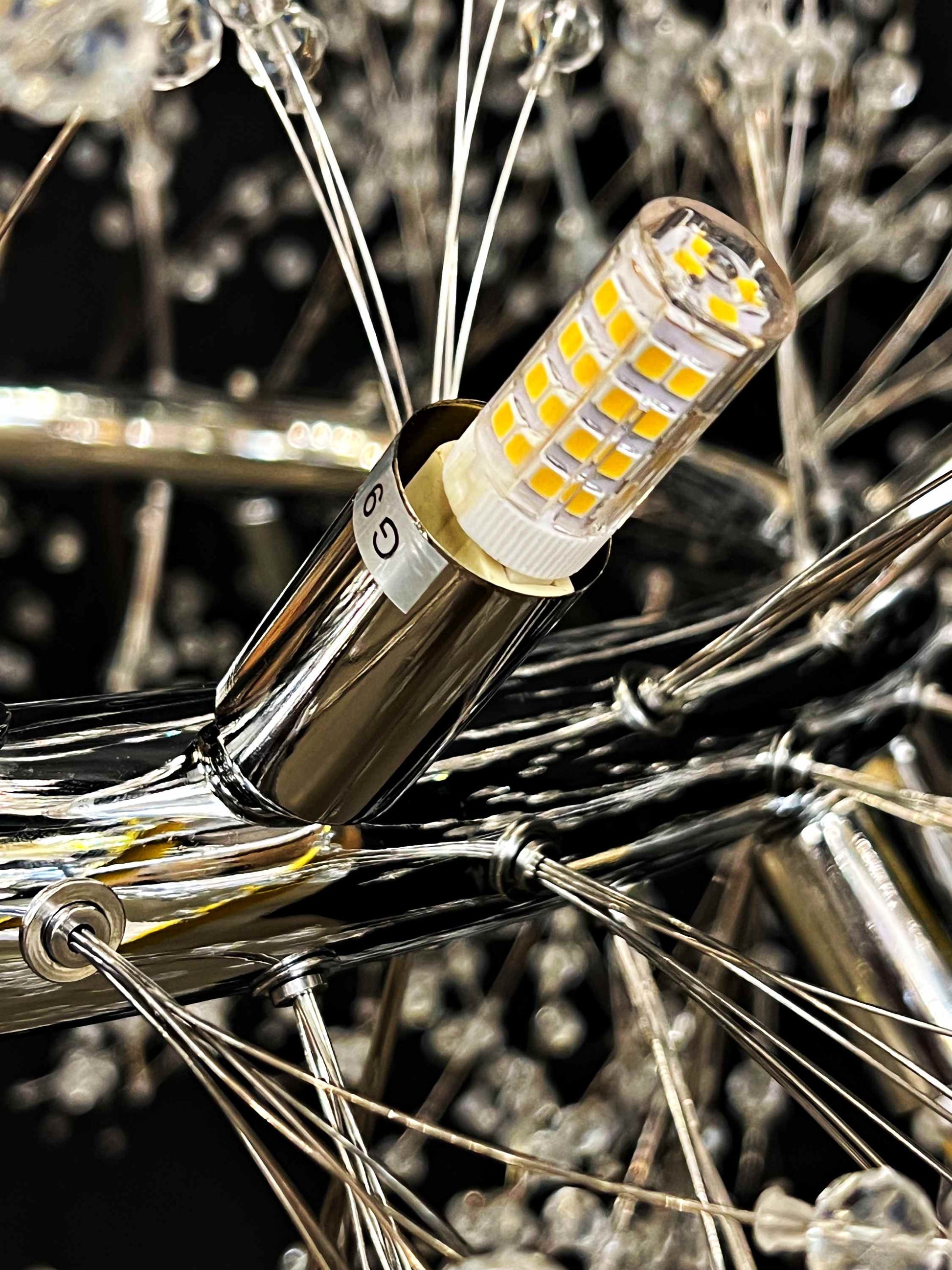 Detailed crystal and metalwork of modern chrome chandelier
