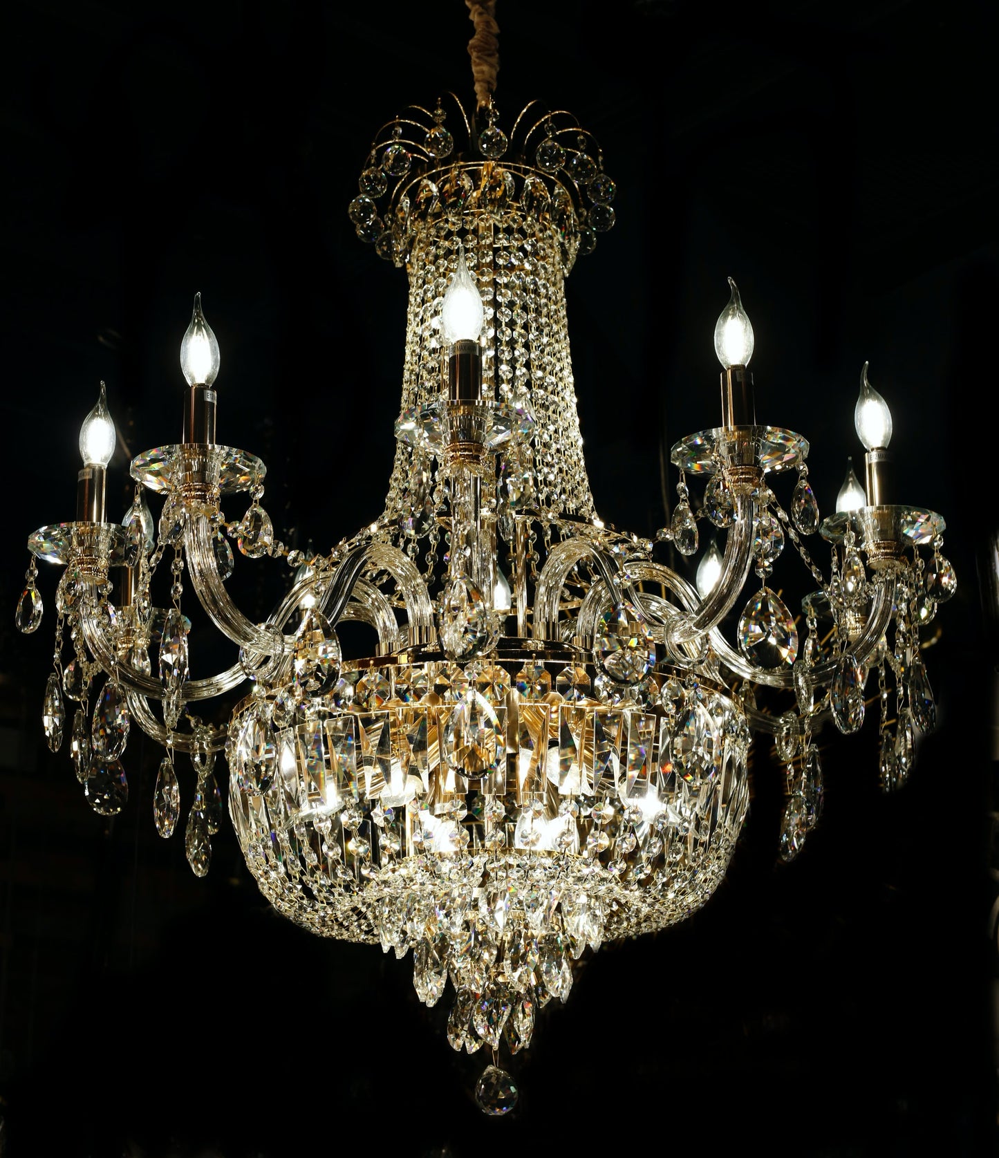 Luxury gold crystal chandelier with empire silhouette and candle-style lights.