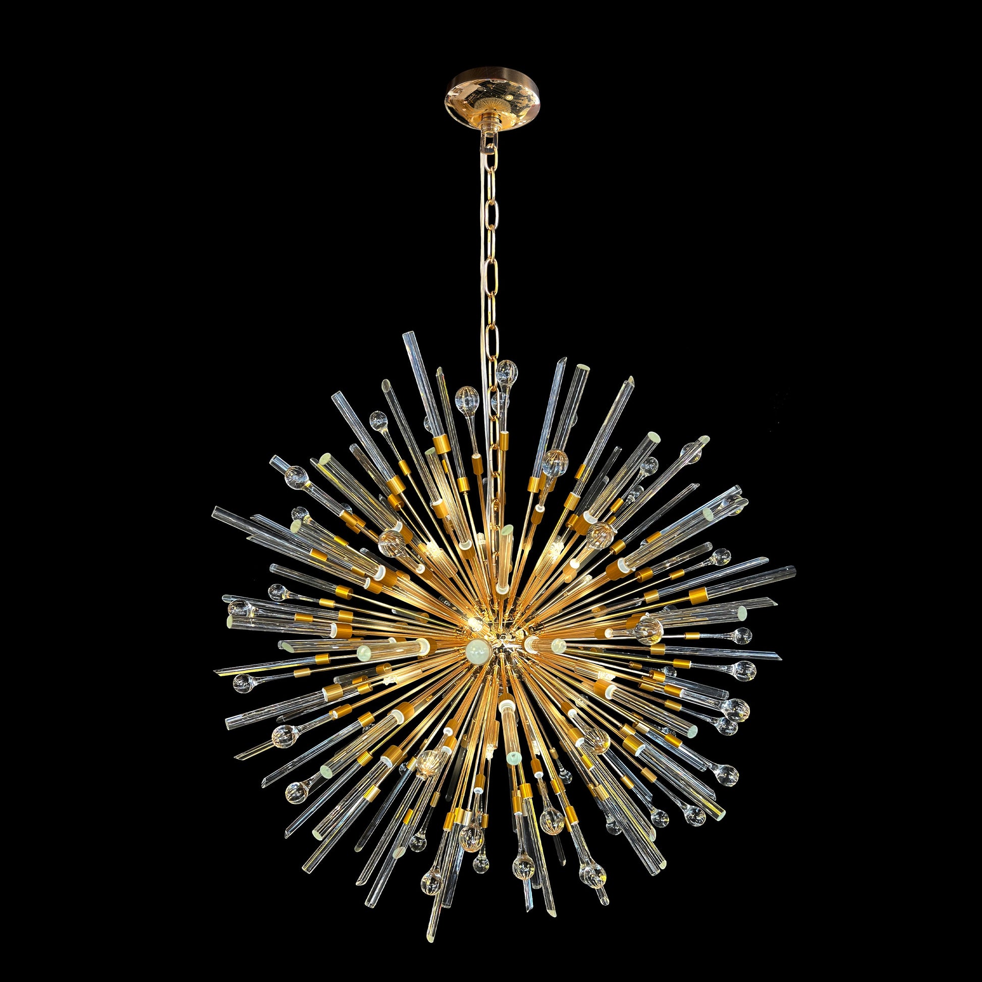 Luxury gold glass pendant chandelier with radiant glow and modern elegance.