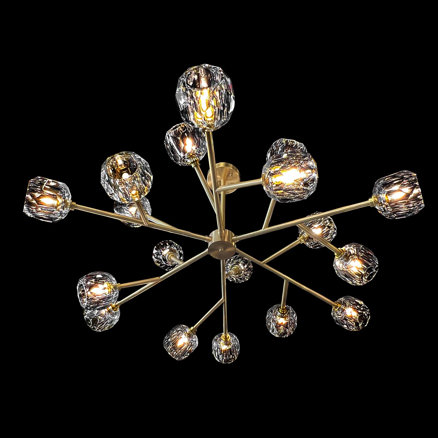  modern brass crystal chandelier on black background