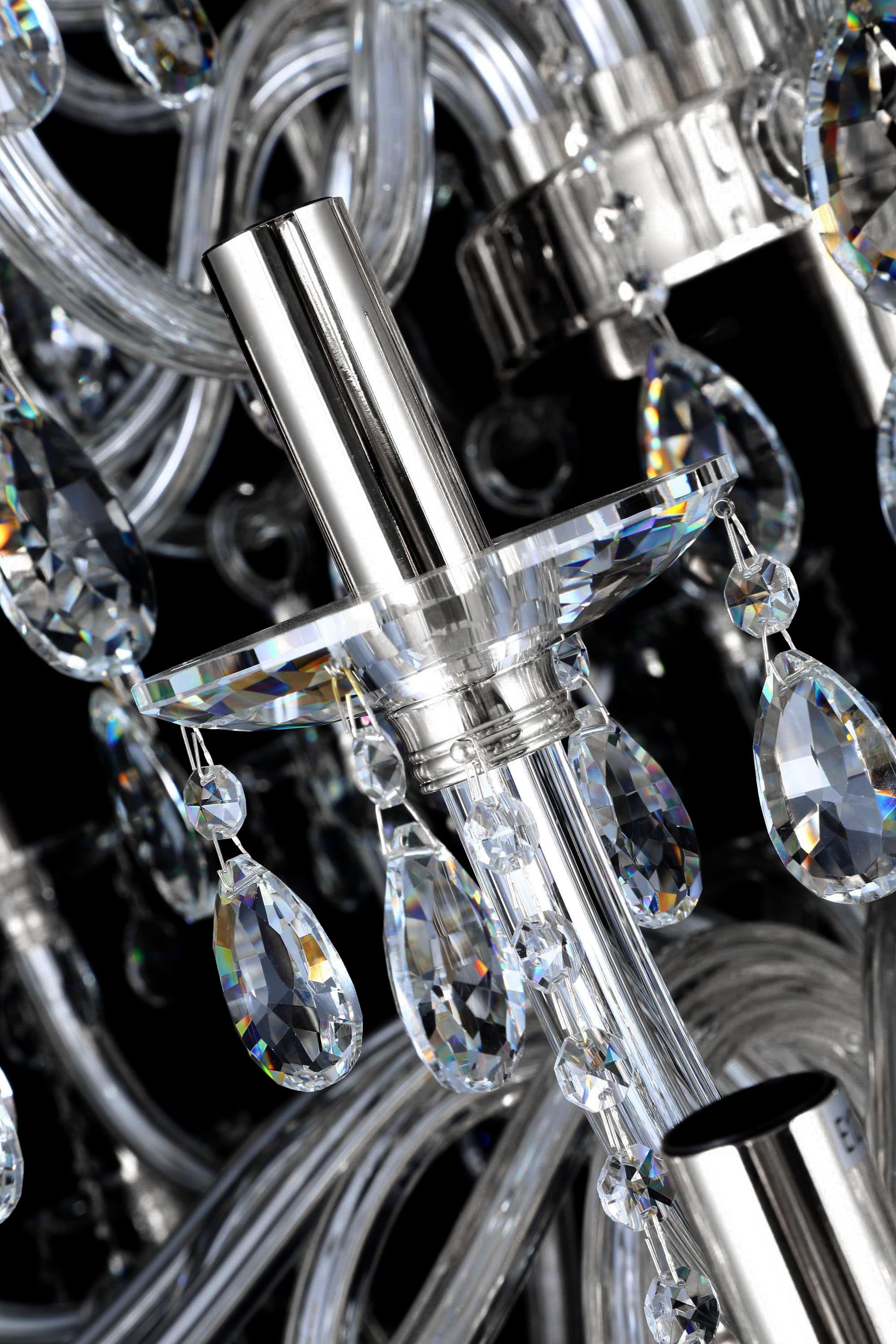 Modern chrome chandelier light holder with intricate crystal drops and reflective metallic finish.