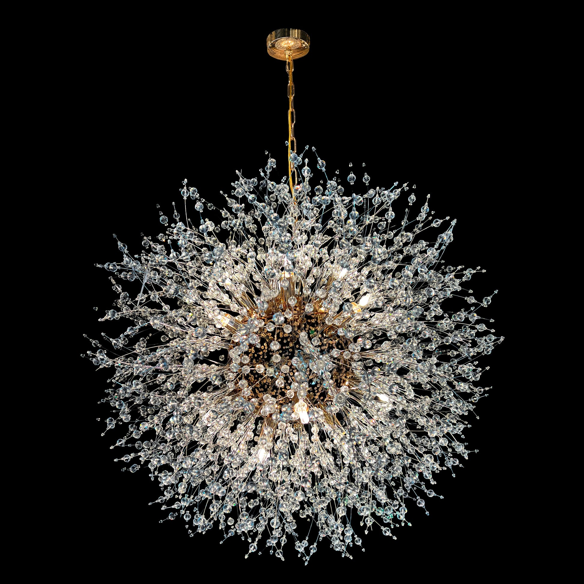 A 24-inch gold crystal chandelier with a starburst design, featuring nano-cut crystal beads and a central gold fixture, hanging from a gold chain.