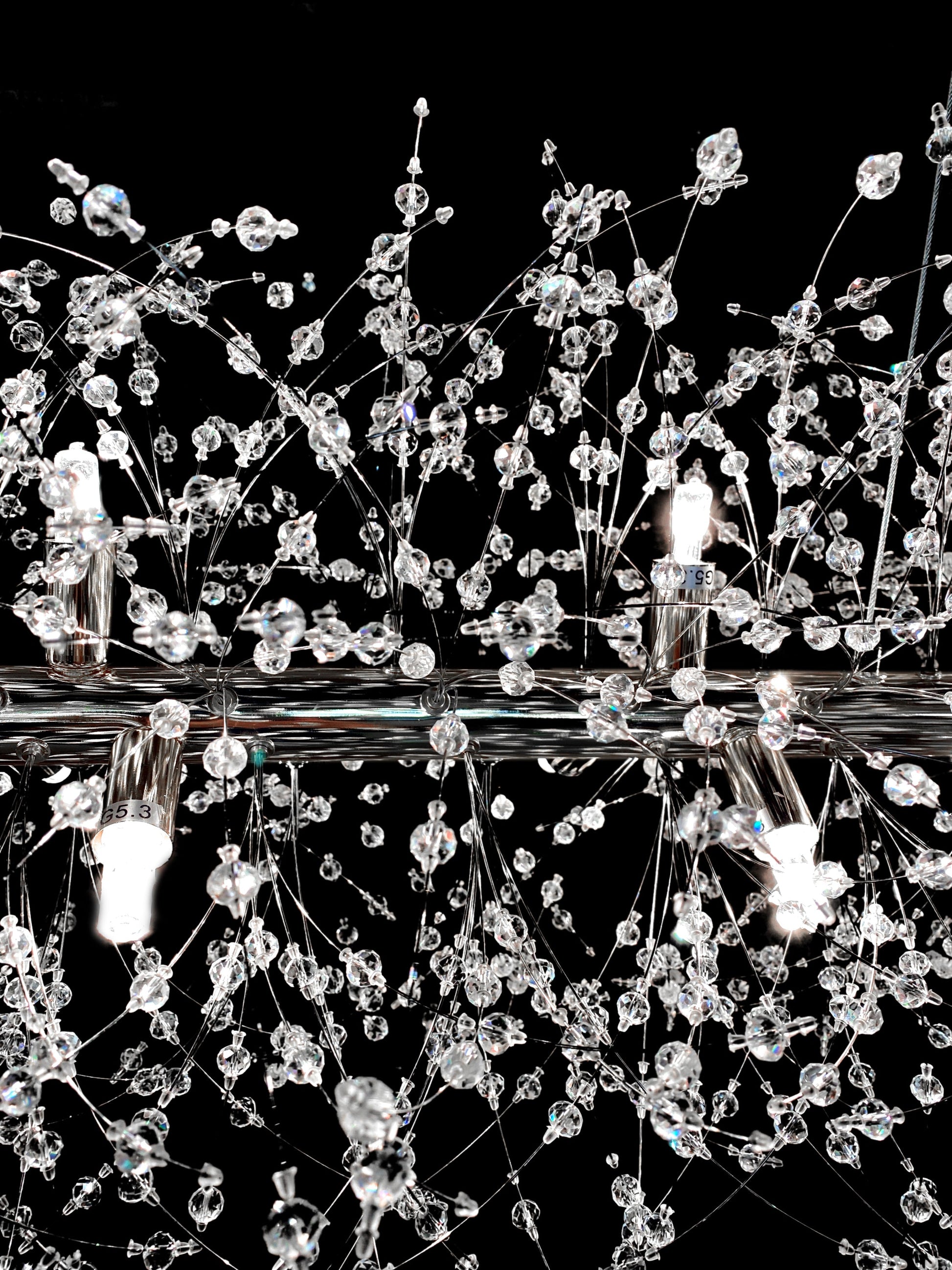 Close-up of dimmable linear crystal chandelier with G9 bulbs