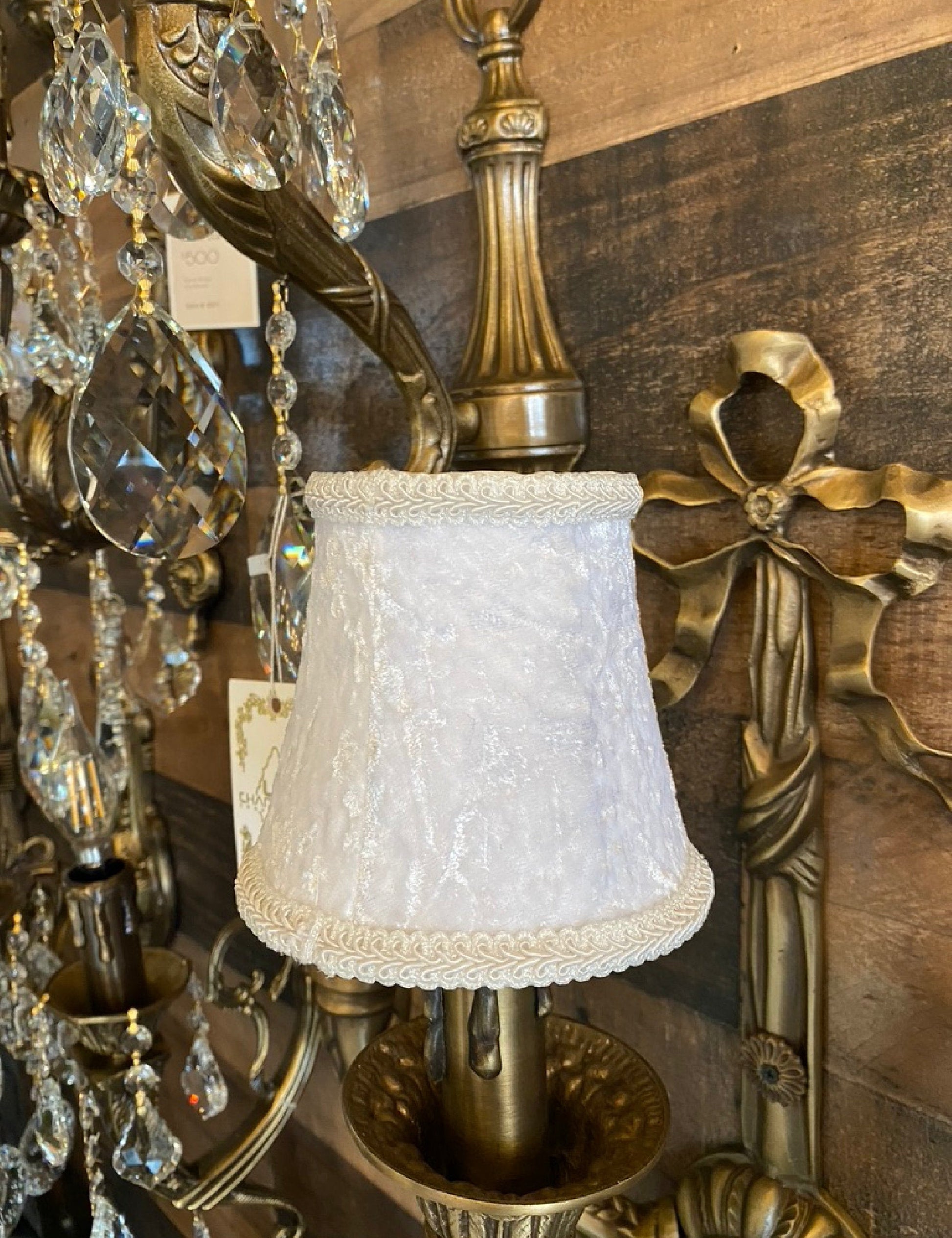 White velvet clip-on shade installed on chandelier arm